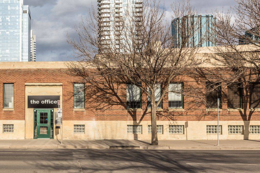 Brick building with "the office" sign
