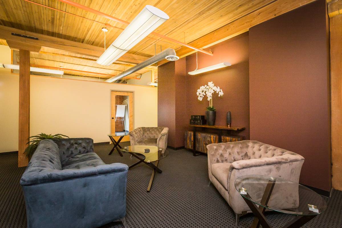 Stylish office space featuring sofas and plants